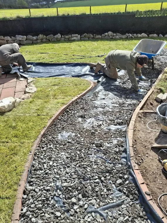 Building the gravel path in one continuous sweep, edged both sides so it holds its line.