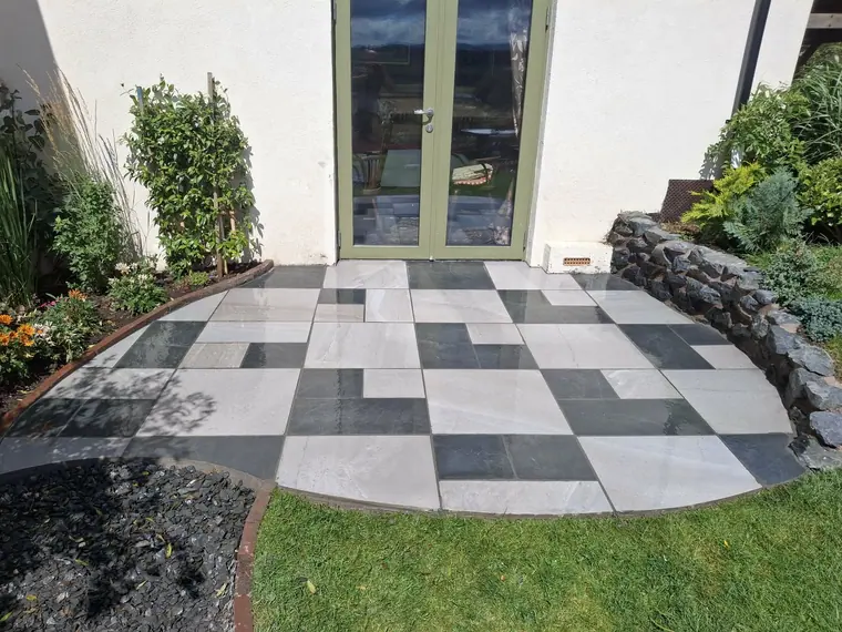 The finished monochrome patio off the French doors, falls set away from the house.