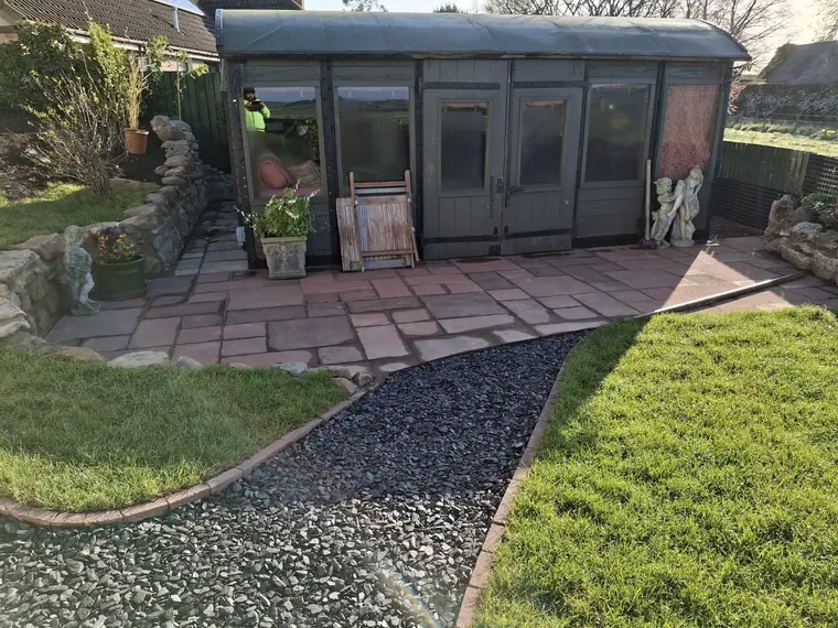 Paving to the sun room doors with a gravel path running off it, so nobody walks mud indoors.