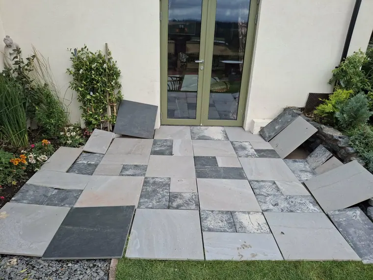Slabs laid out across the base to check falls and joint lines before the mortar goes down.