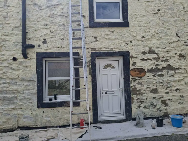 Render made good around the door and windows, waiting on the masonry paint once it has cured.