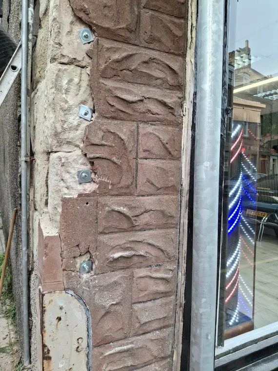 Close-up of the indented sandstone repair, pinned and bedded before the joints are pointed up.