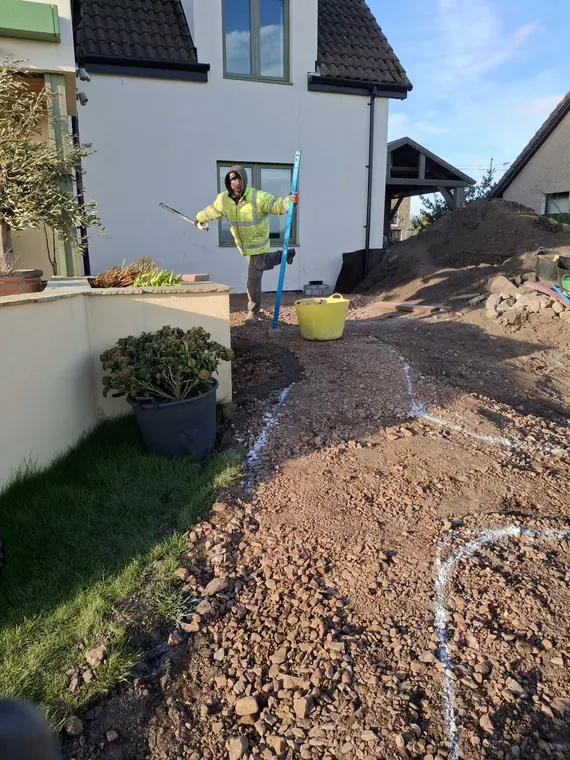 Marking the curves out on the ground so the client can walk the shape before a single edging is laid.